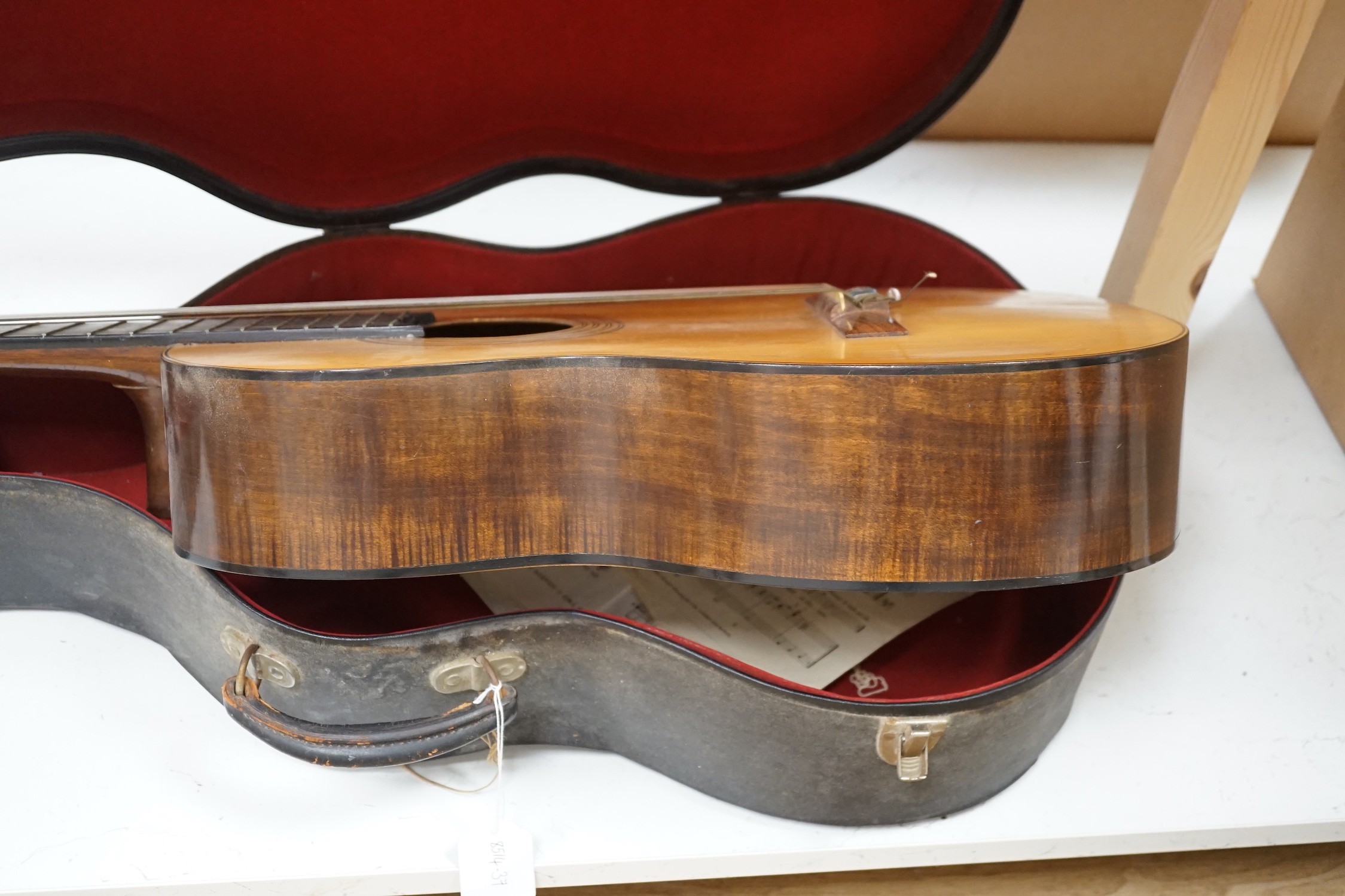 A Harald Petersen classical concert guitar, paper label interior, with hard case. Length of back 49cm excluding button